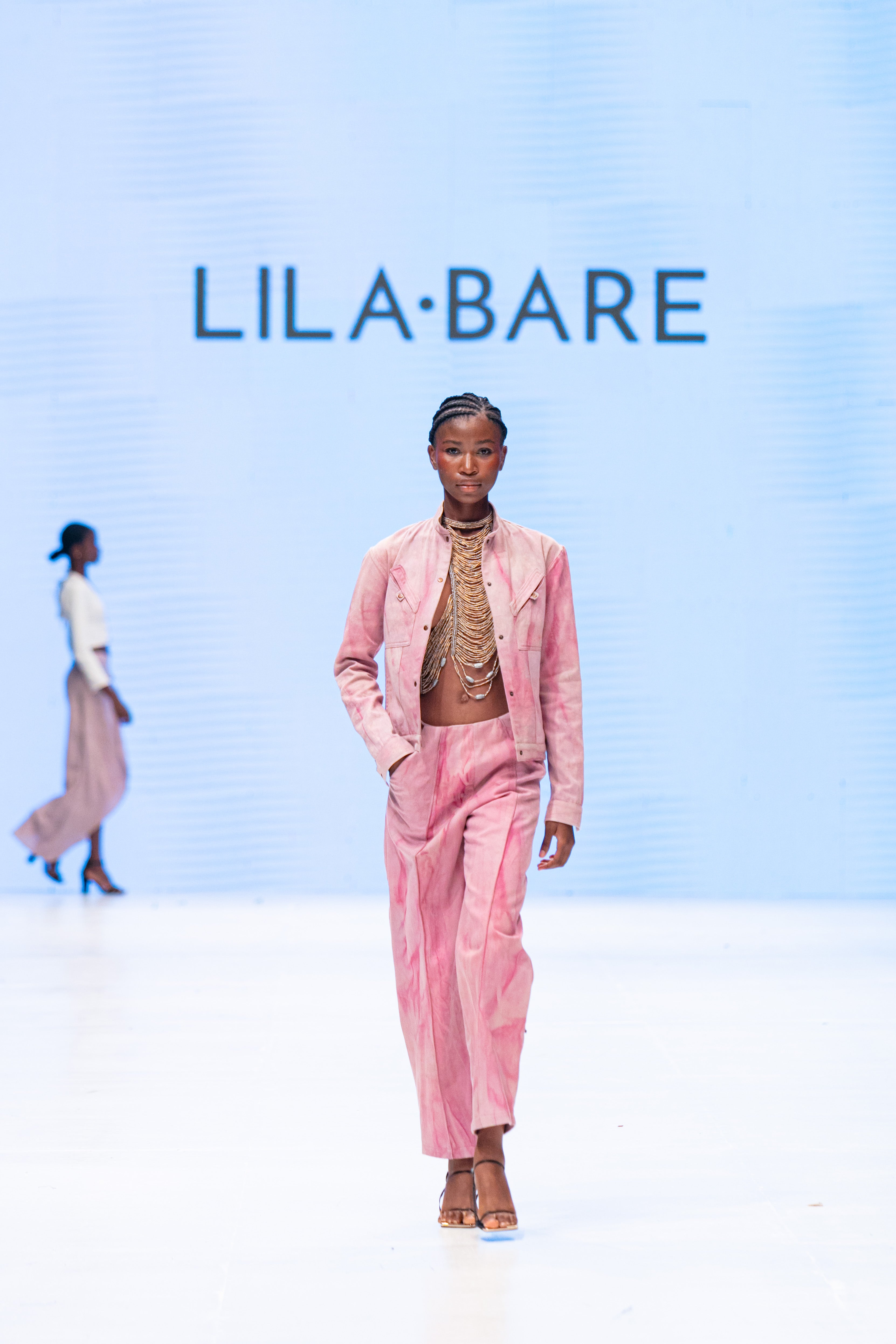 Handmade luxury leather and bead halter by LilaBare on runway with pink separates