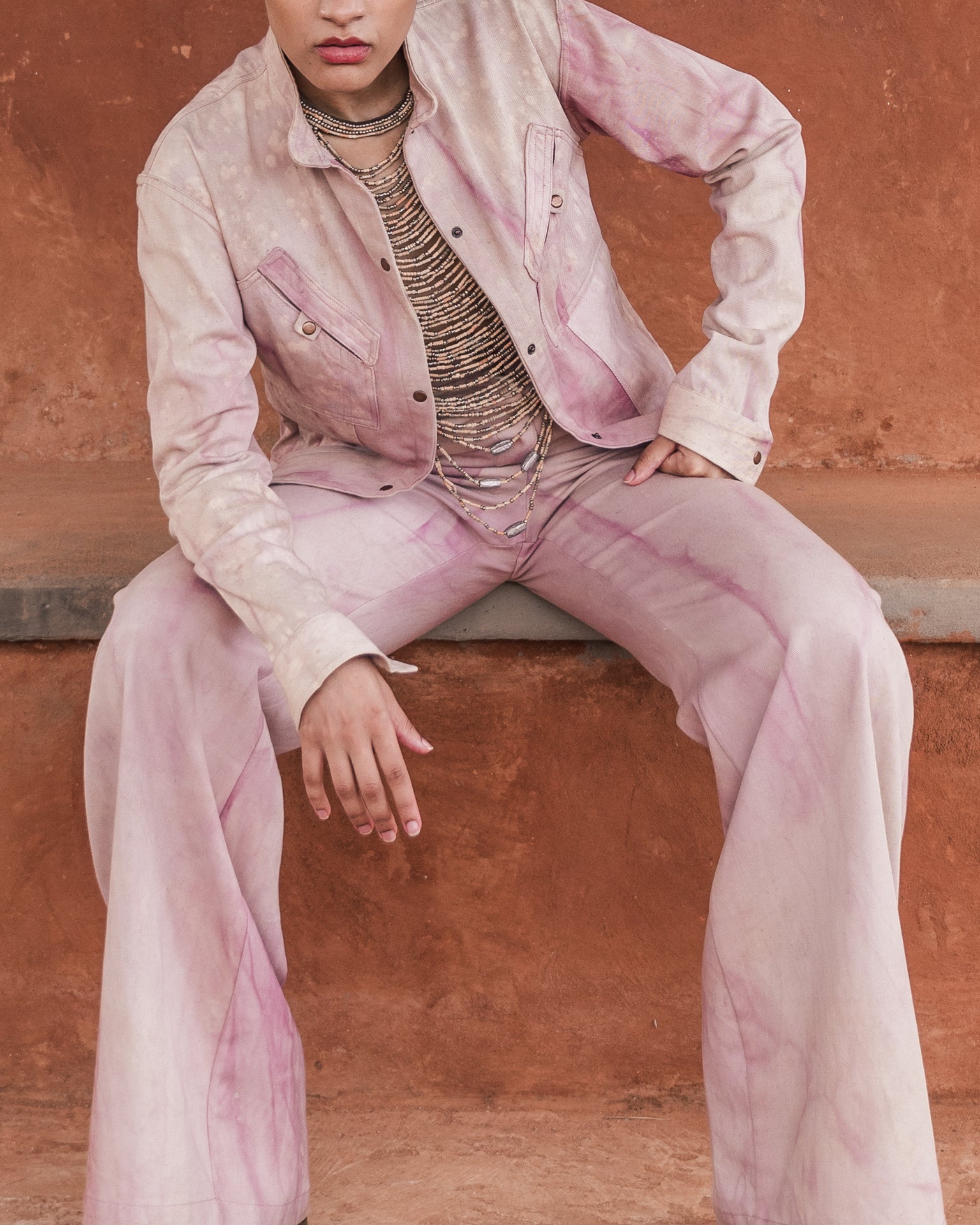 Handmade luxury leather and bead halter by LilaBare with pink jacket and trousers