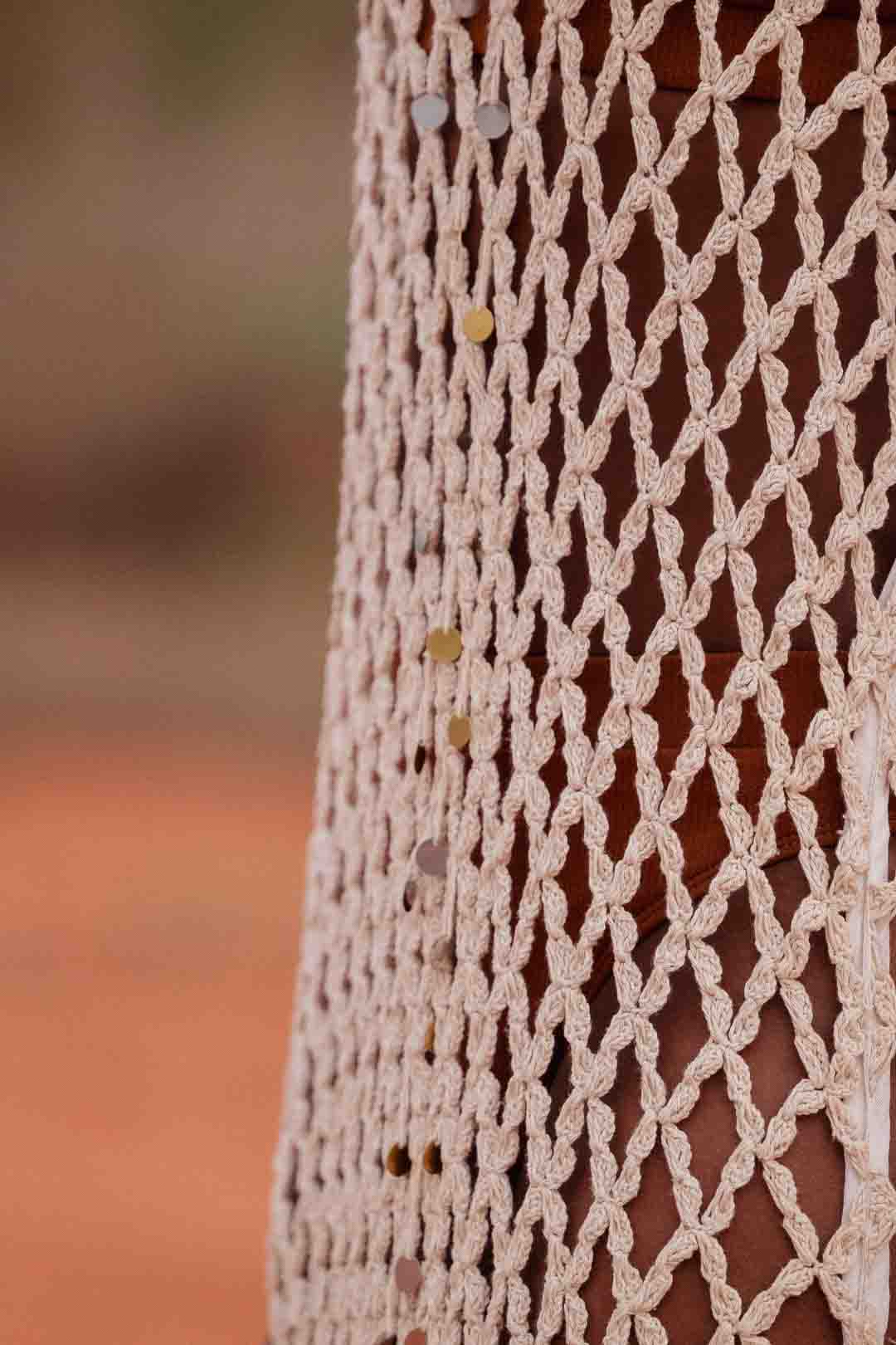 Detail of handmade crochet dera dress by African designer brand LilaBare — featuring hand-beaded sequins and artisan craftsmanship