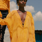 Close-up of plunge neckline and brass closures on LilaBare’s naturally dyed kaftan tunic