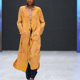 Close-up of plunge neckline and brass closures on LilaBare’s naturally dyed kaftan tunic