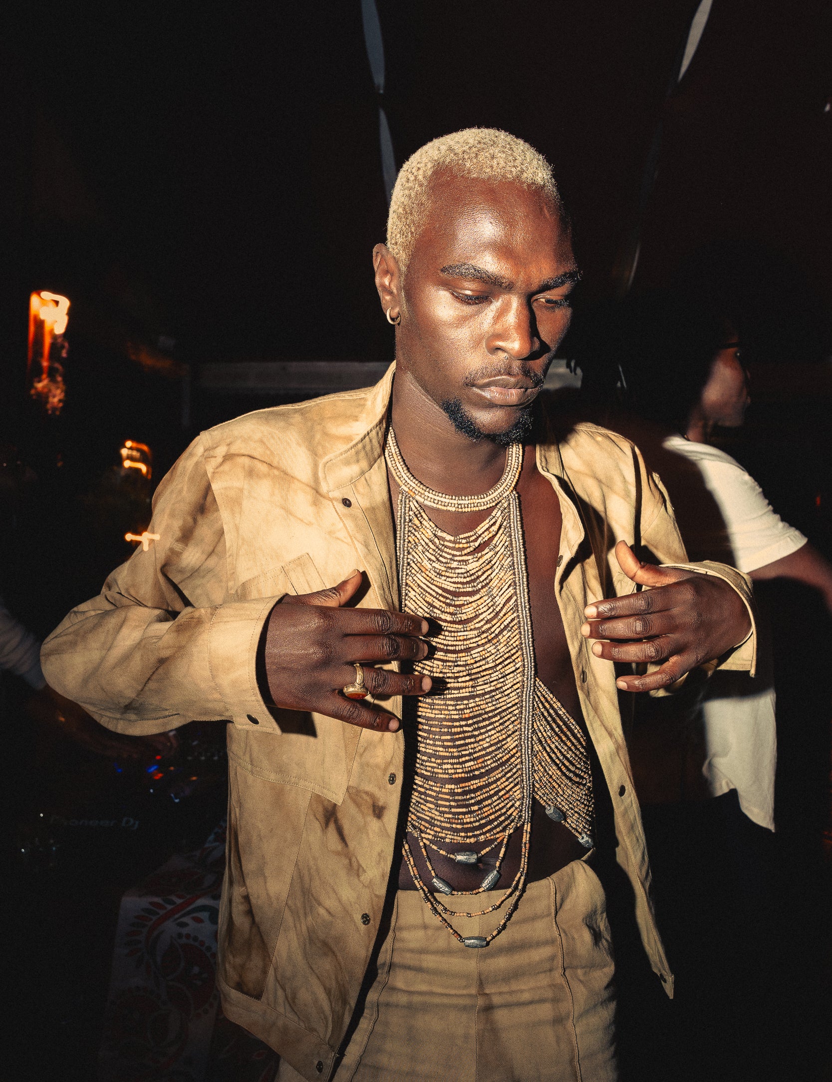 Model wearing marbled safari jacket in natural ochre tie-dye against 