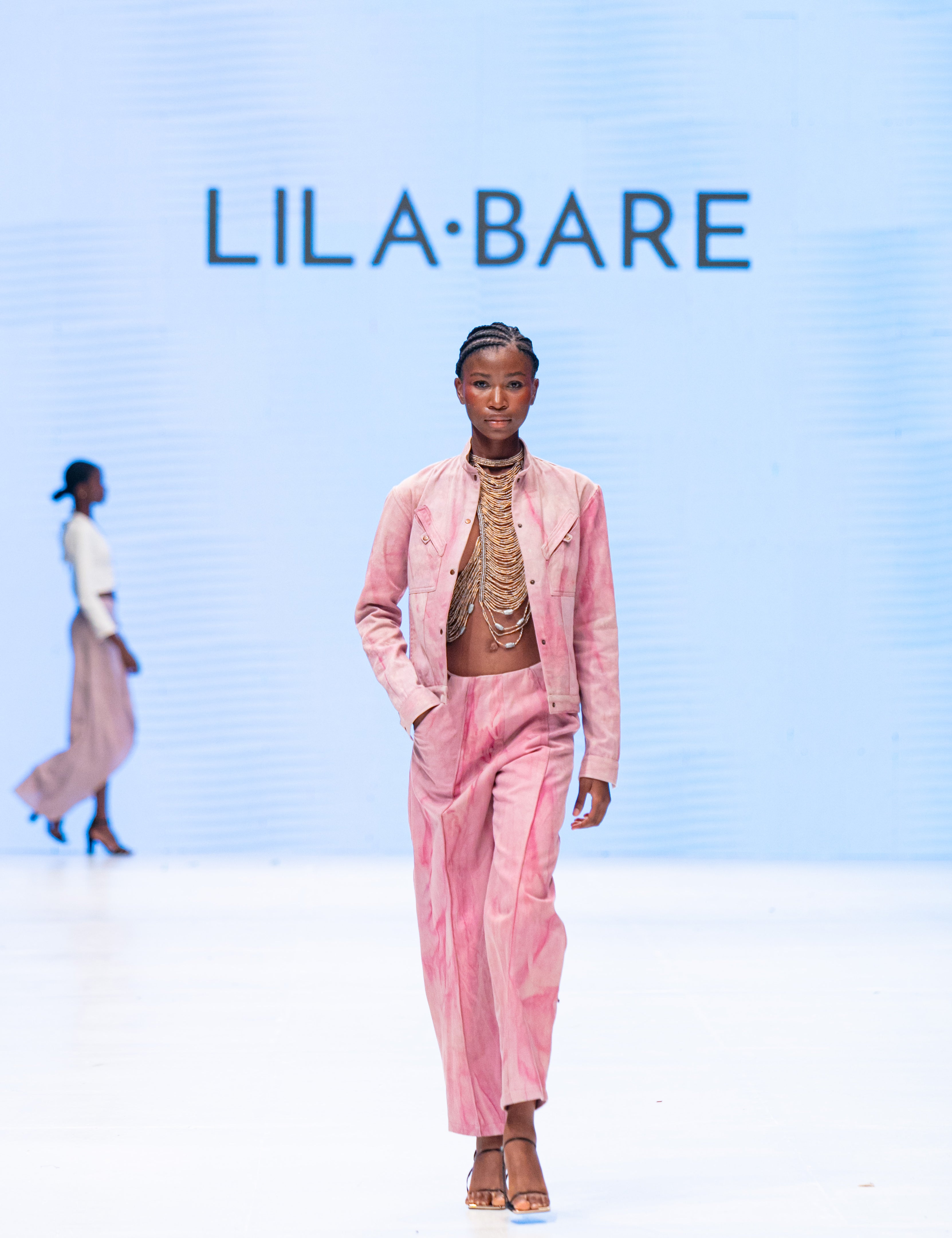 Handmade luxury leather and bead halter by LilaBare on runway with pink separates