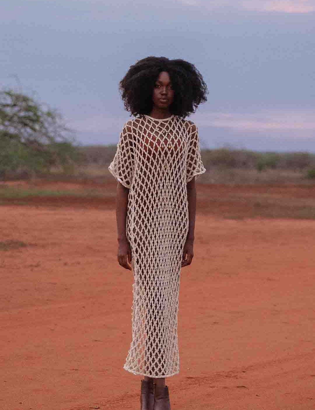 Model wearing handmade crochet dera dress by African designer brand LilaBare — featuring hand-beaded sequins and artisan craftsmanship