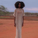 Model wearing handmade crochet dera dress by African designer brand LilaBare — featuring hand-beaded sequins and artisan craftsmanship