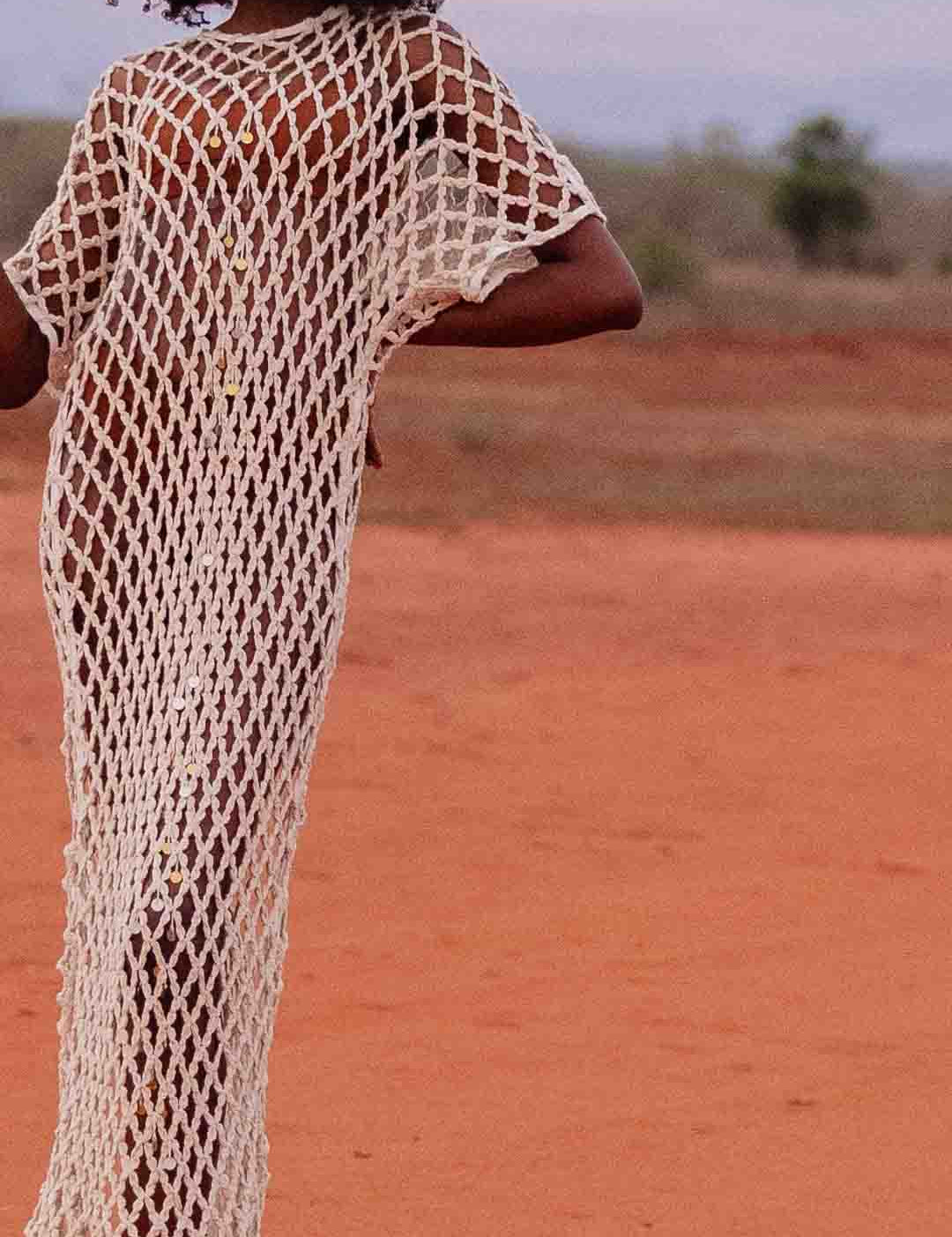 Close up Model wearing handmade crochet dera dress by African designer brand LilaBare — featuring hand-beaded sequins and artisan craftsmanship
