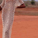 Close up Model wearing handmade crochet dera dress by African designer brand LilaBare — featuring hand-beaded sequins and artisan craftsmanship
