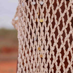 close up of Model wearing handmade crochet dera dress by African designer brand LilaBare — featuring hand-beaded sequins and artisan craftsmanship