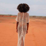 Back view of model wearing handmade crochet dera dress by African designer brand LilaBare — featuring hand-beaded sequins and artisan craftsmanship