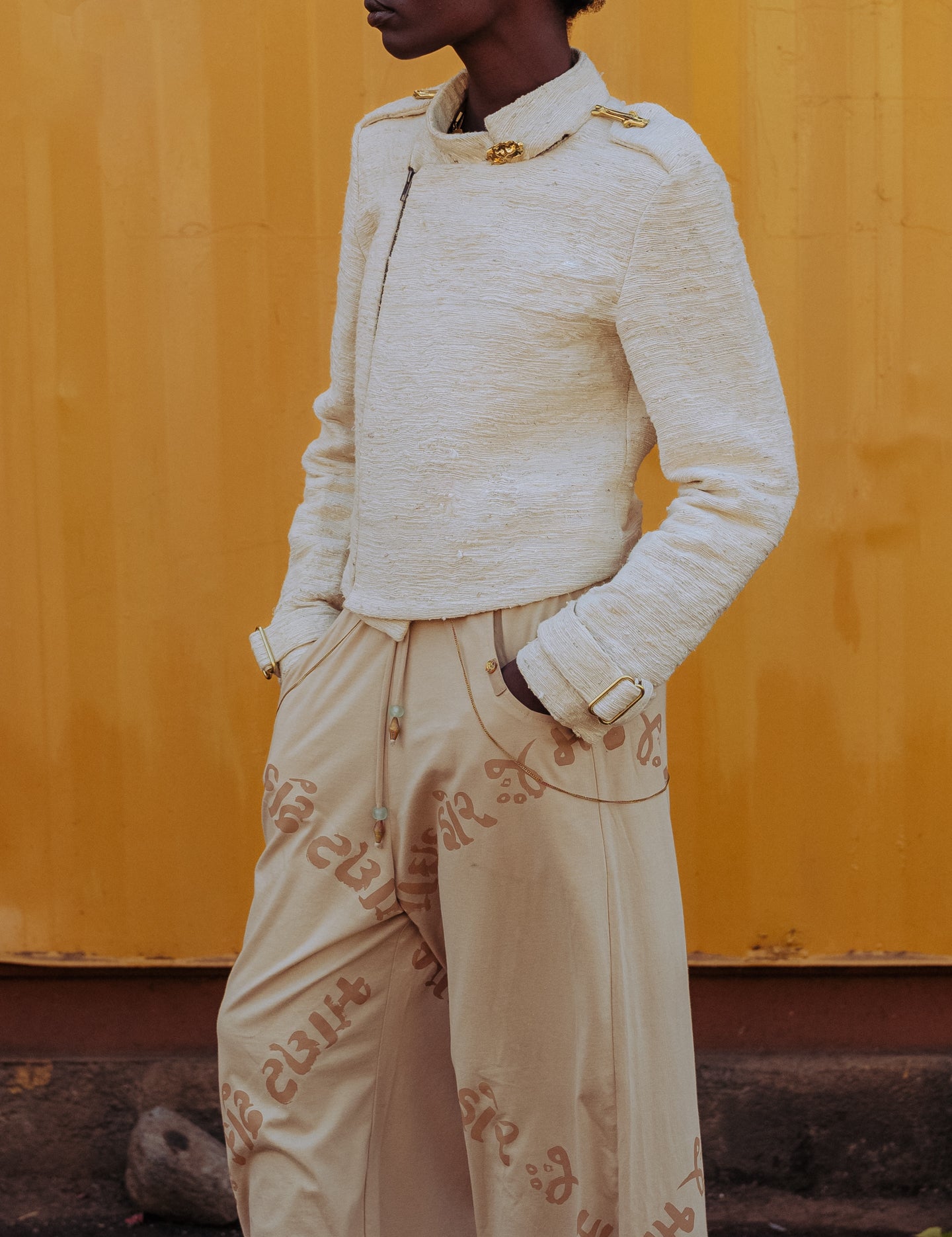 Side profile of sustainably made structured moto jacket in natural pineapple fiber fabric