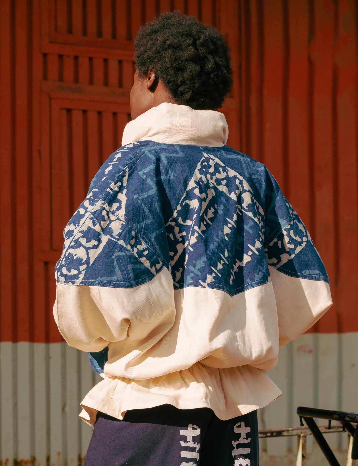 Back view of model in hand-blockprinted oversized jacket in indigo hues, ethically made in Kenya by LilaBare.