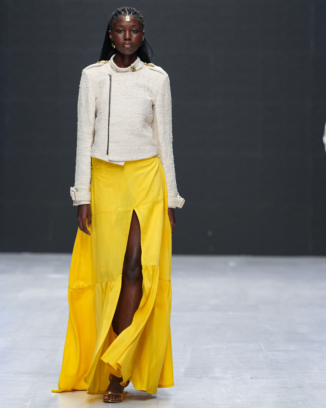Model styled in pineapple waste moto jacket on runway, showcasing natural elegance and strong tailoring