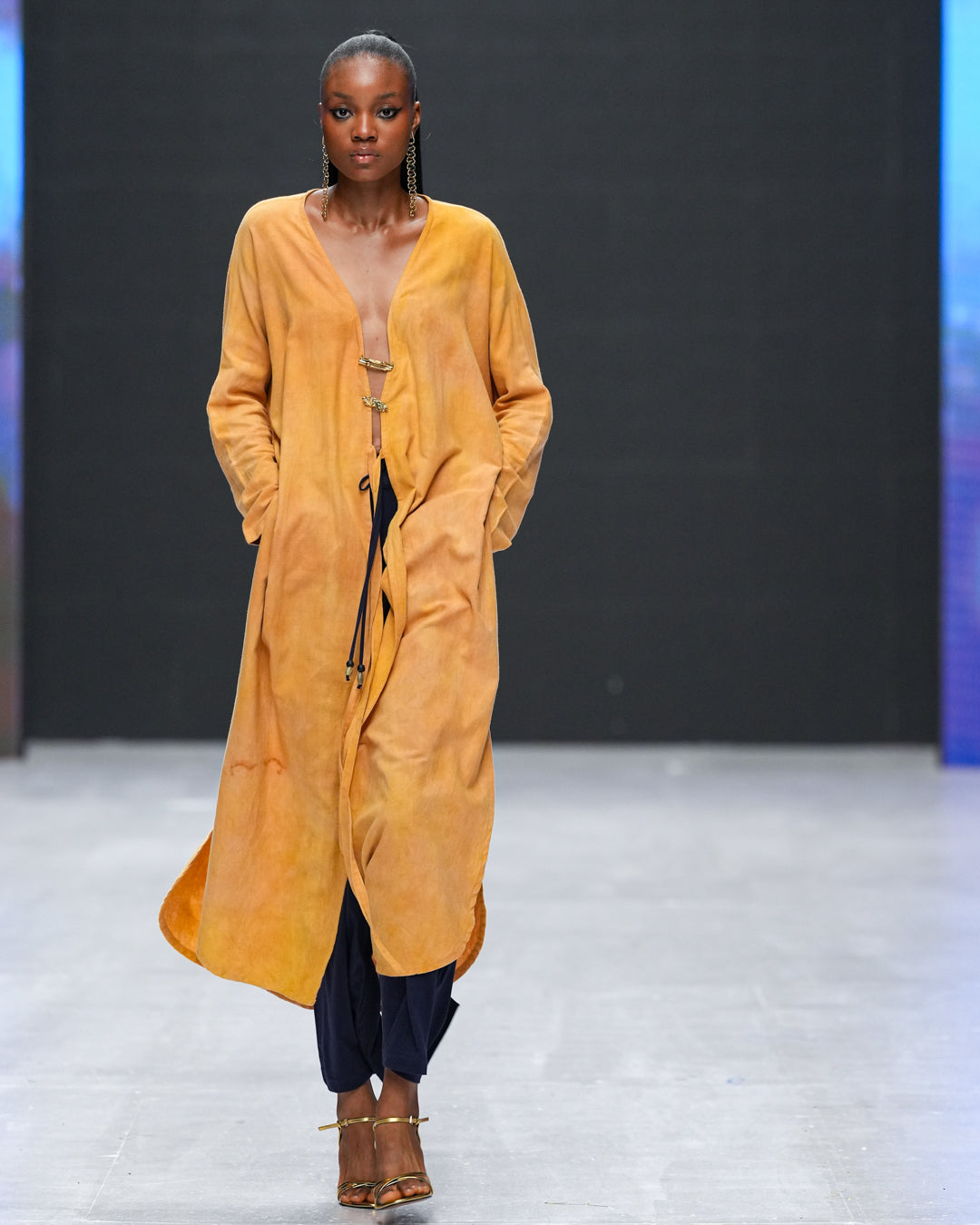 Close-up of plunge neckline and brass closures on LilaBare’s naturally dyed kaftan tunic