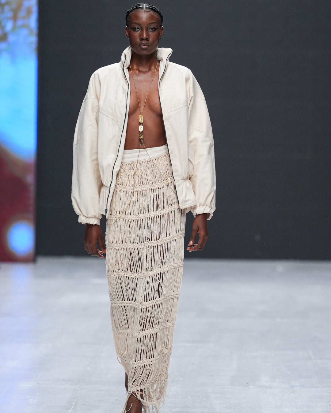 Gender-neutral fashion jacket in Kenyan woven cotton worn by runway model
