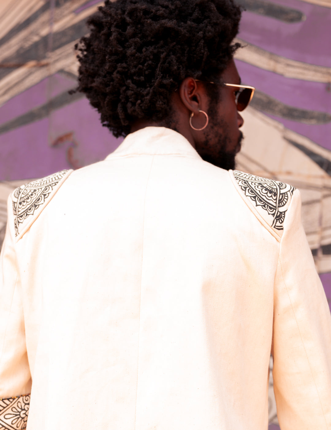 Back view close up of model in structured blazer with gold beadwork by LilaBare