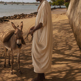 Side view of the flowing asymmetrical silhouette of LilaBare’s sari-inspired dress made in Kenya.