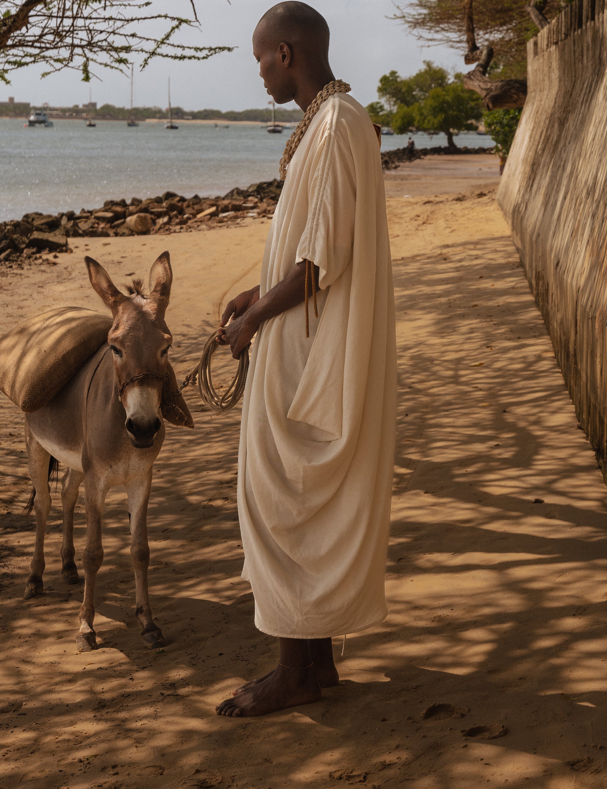 Side view of the flowing asymmetrical silhouette of LilaBare’s sari-inspired dress made in Kenya.