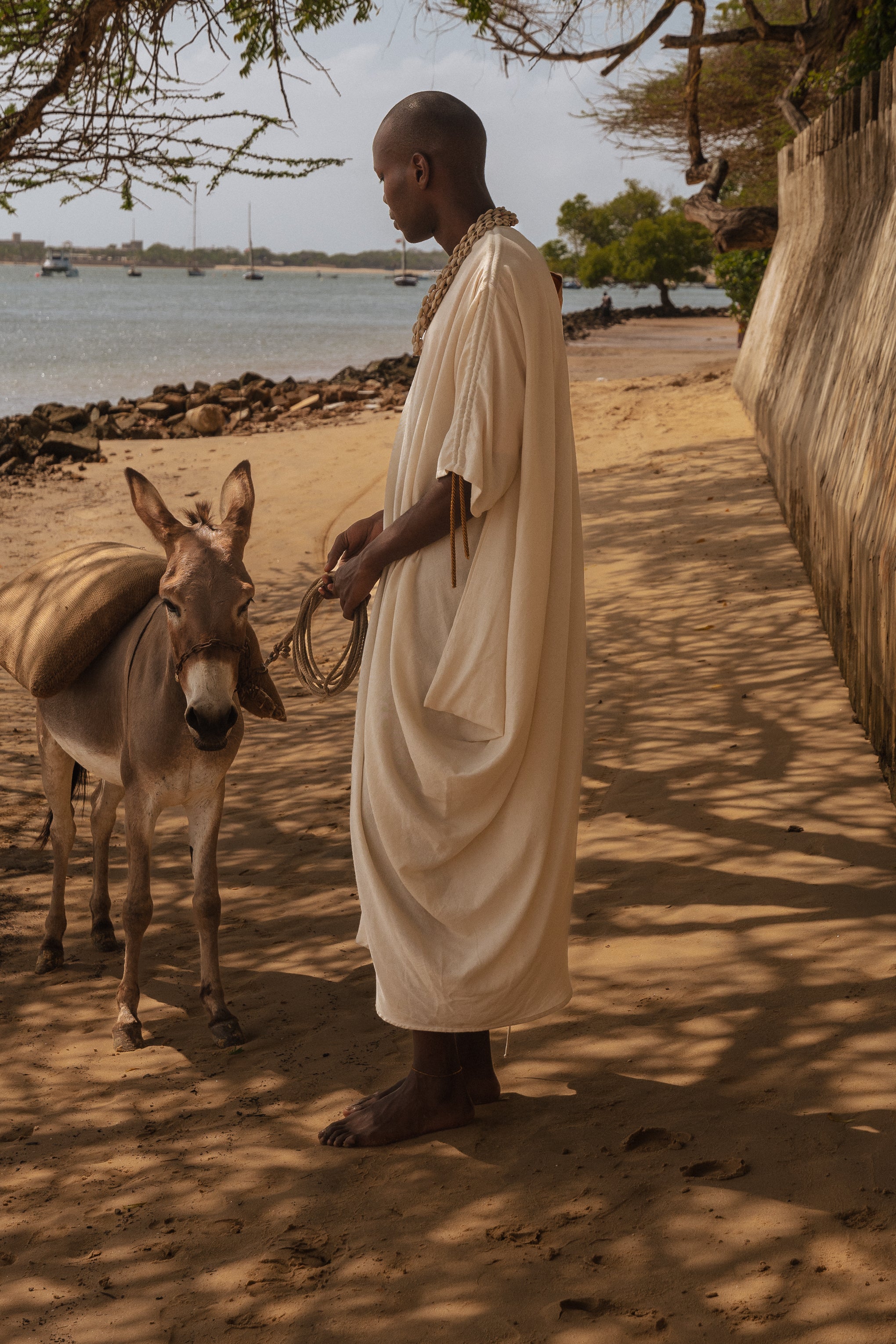 Side view of the flowing asymmetrical silhouette of LilaBare’s sari-inspired dress made in Kenya.