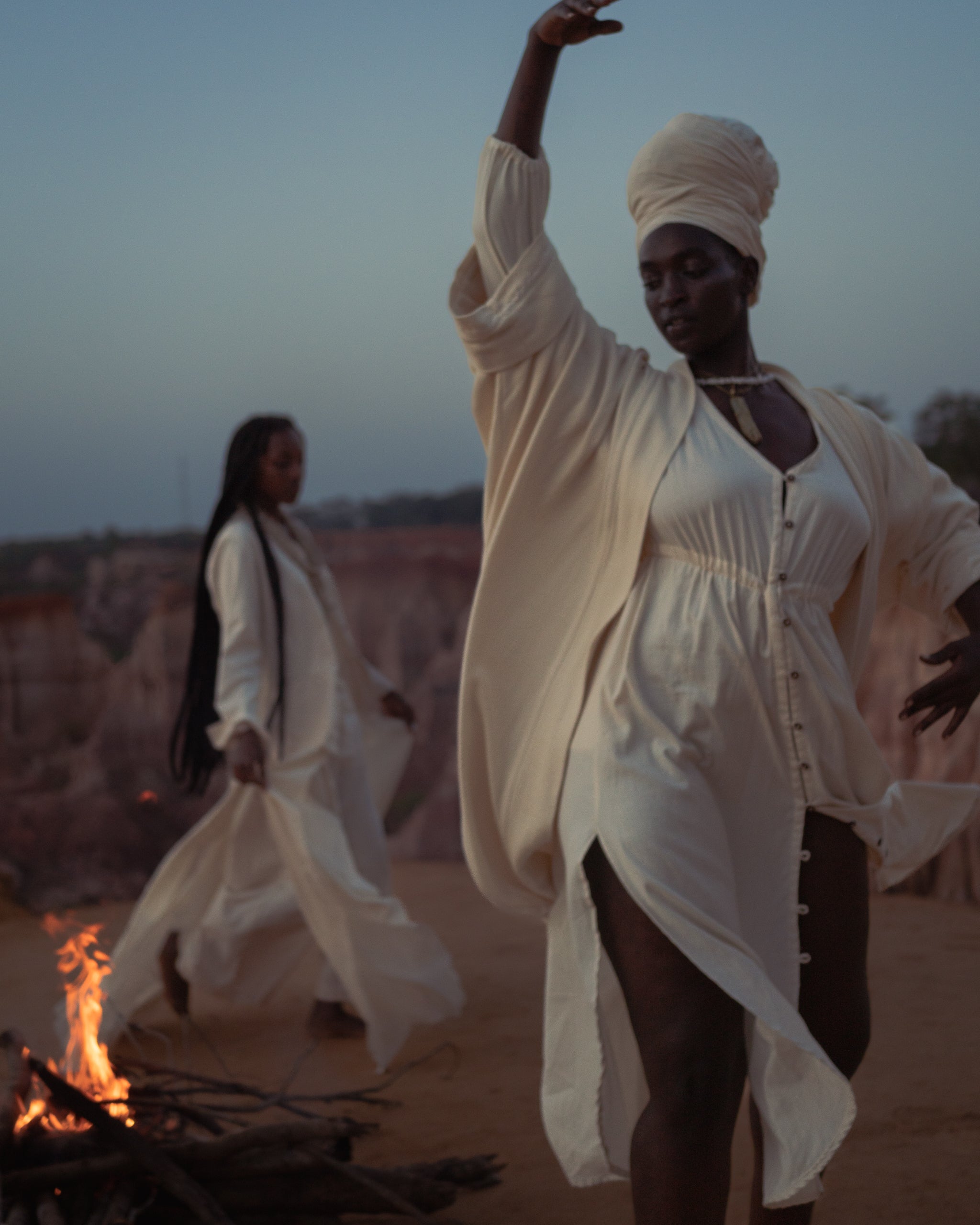 Woman dancing in flowing LilaBare Louise Cape Dress made of handwoven cotton