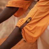 Close-up of Storm Kimono sleeve with brass button detail