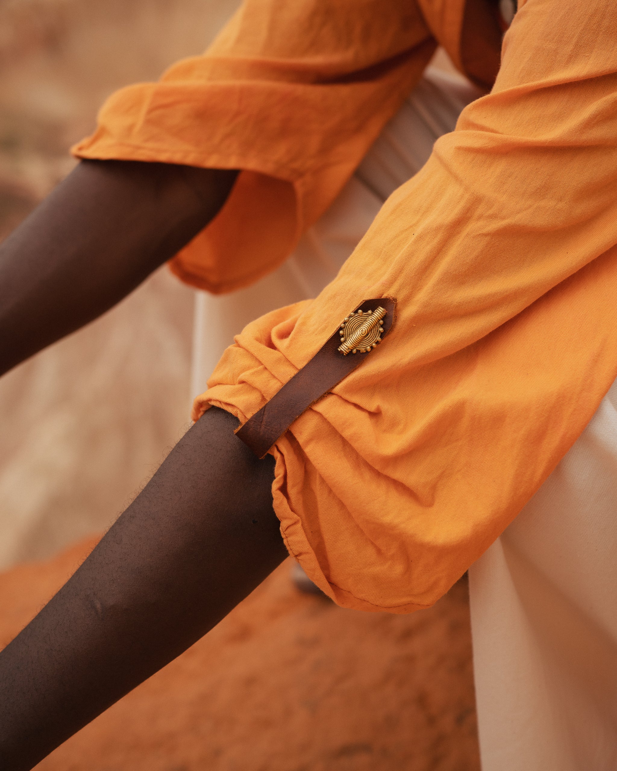 Close-up of Storm Kimono sleeve with brass button detail